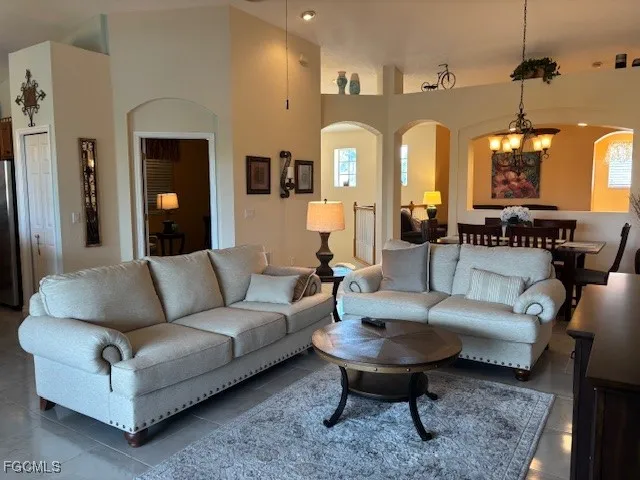 a living room with furniture and a chandelier
