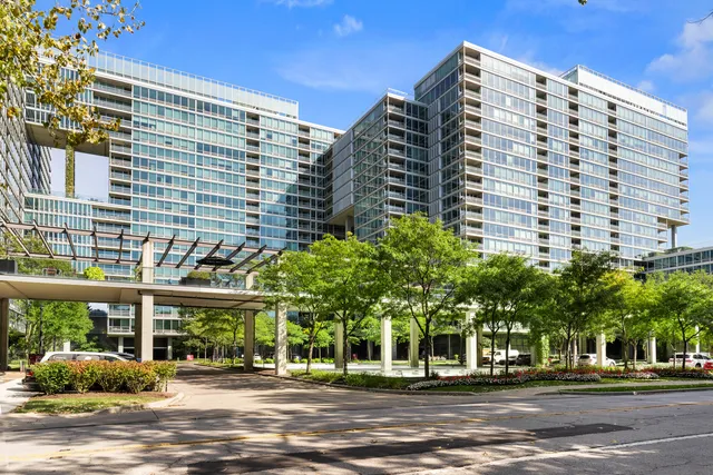 a dining room with furniture a chandelier and wooden floor
