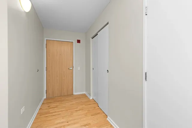 a kitchen with stainless steel appliances granite countertop a refrigerator a stove and a wooden floors