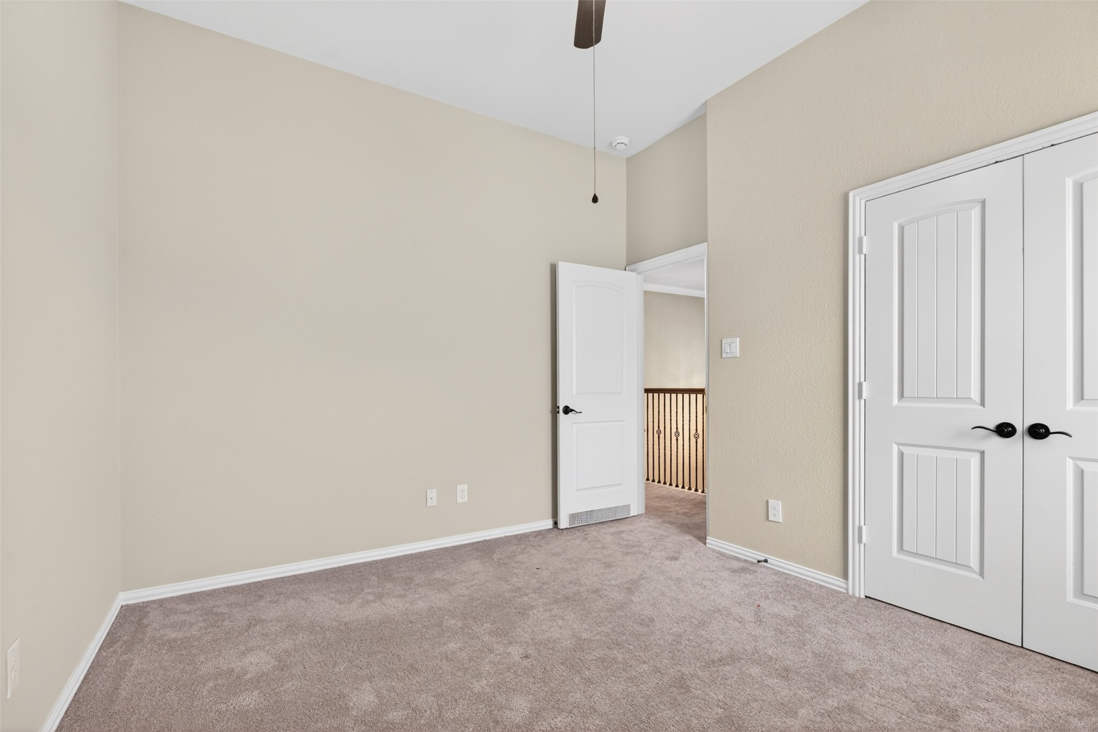 18202 Wedgewood Bluff Court Spring, TX 77379 - Photo 43 of 50 Secondary bedroom view showing closet doors and access to hallway.