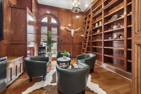 a dining room with furniture a potted plant and a chandelier