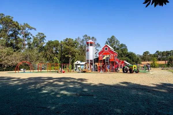 a childrens park with lots of trees and plants