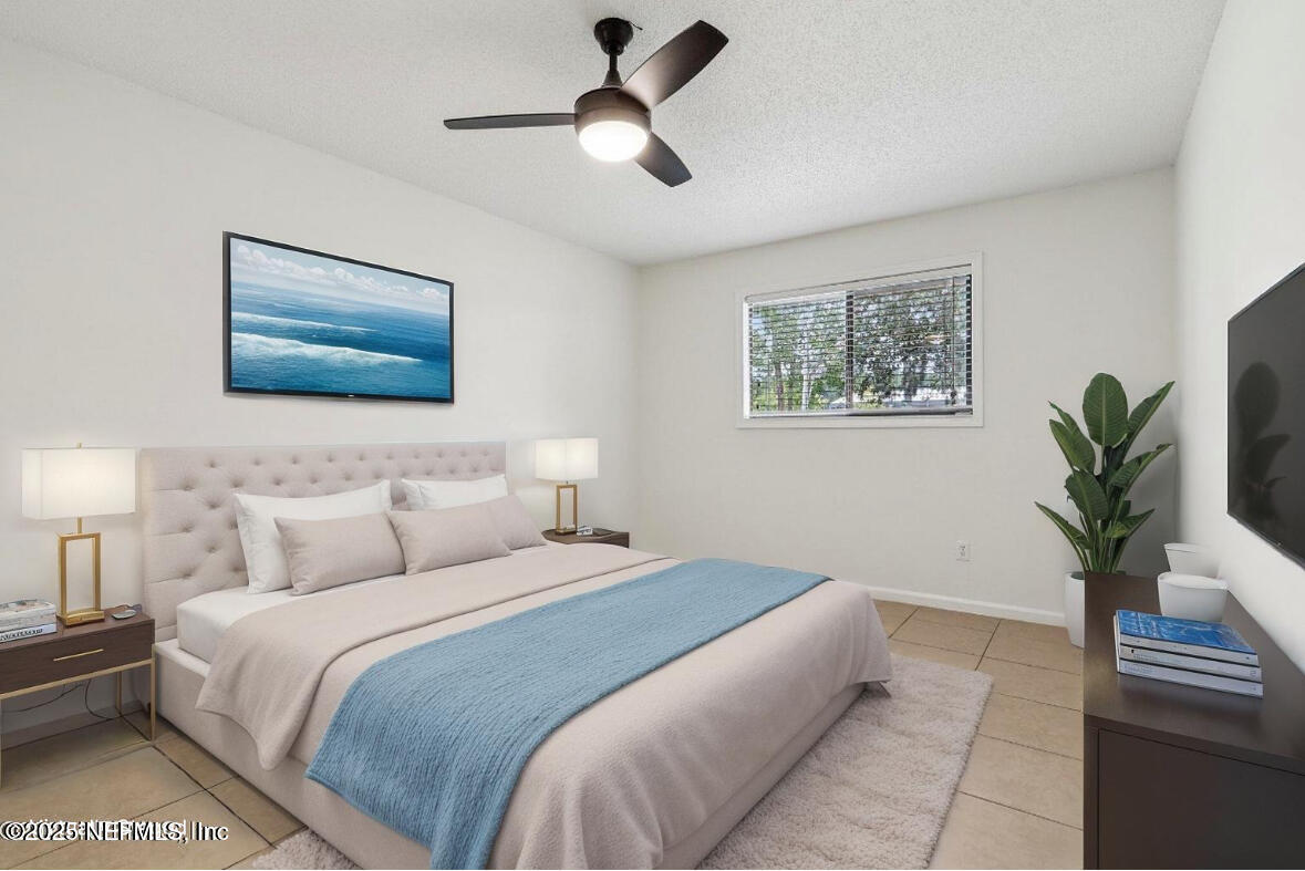 3801 Crown Point Road, Unit 2024 Jacksonville, FL 32257 - Photo 12 of 36 a bedroom with a large bed and a chandelier