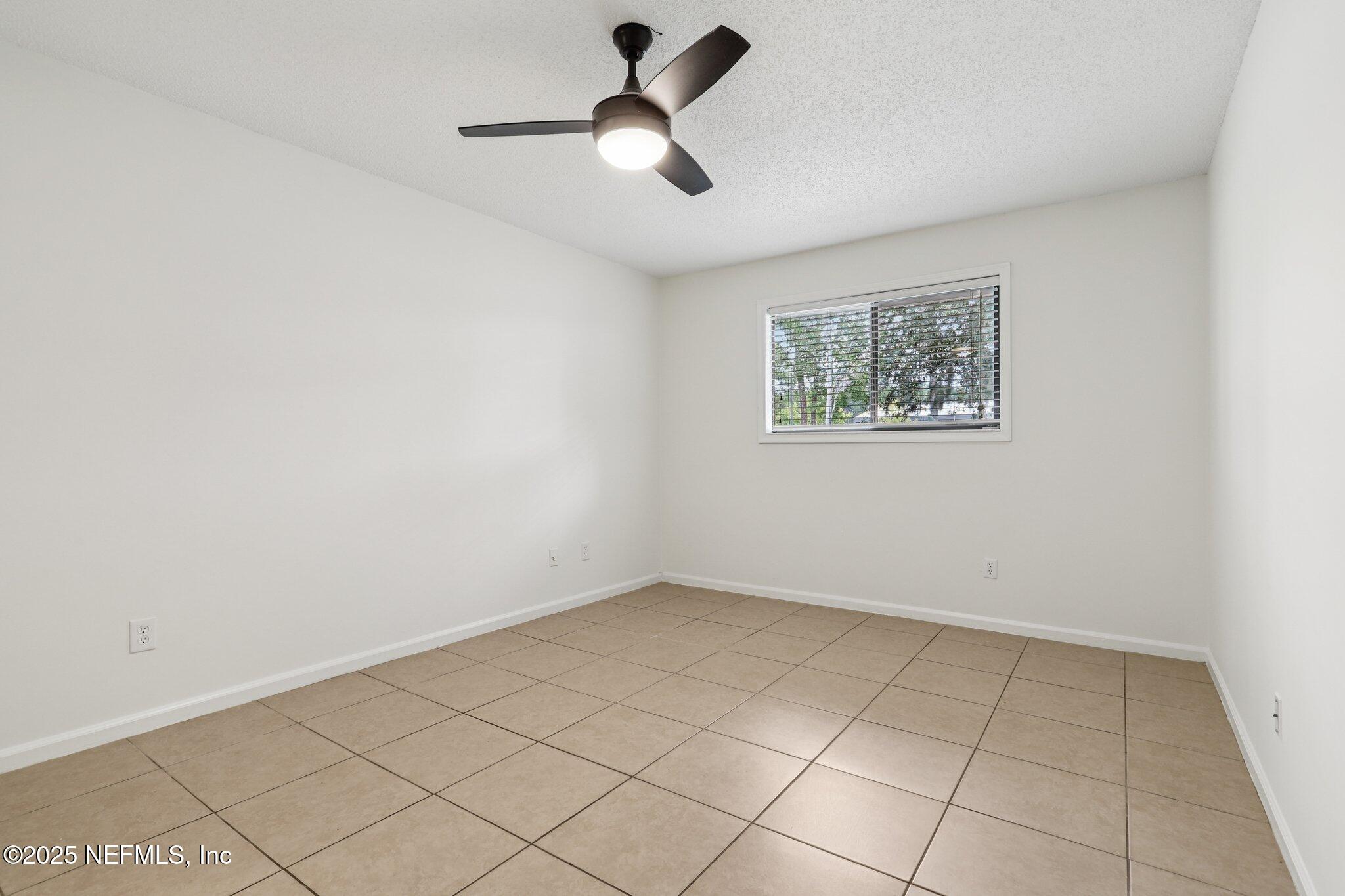 3801 Crown Point Road, Unit 2024 Jacksonville, FL 32257 - Photo 13 of 36 wooden floor in an empty room with a window