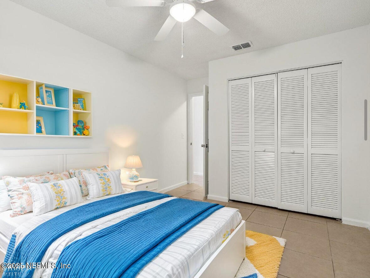 3801 Crown Point Road, Unit 2024 Jacksonville, FL 32257 - Photo 14 of 36 a bedroom with a bed and a chandelier