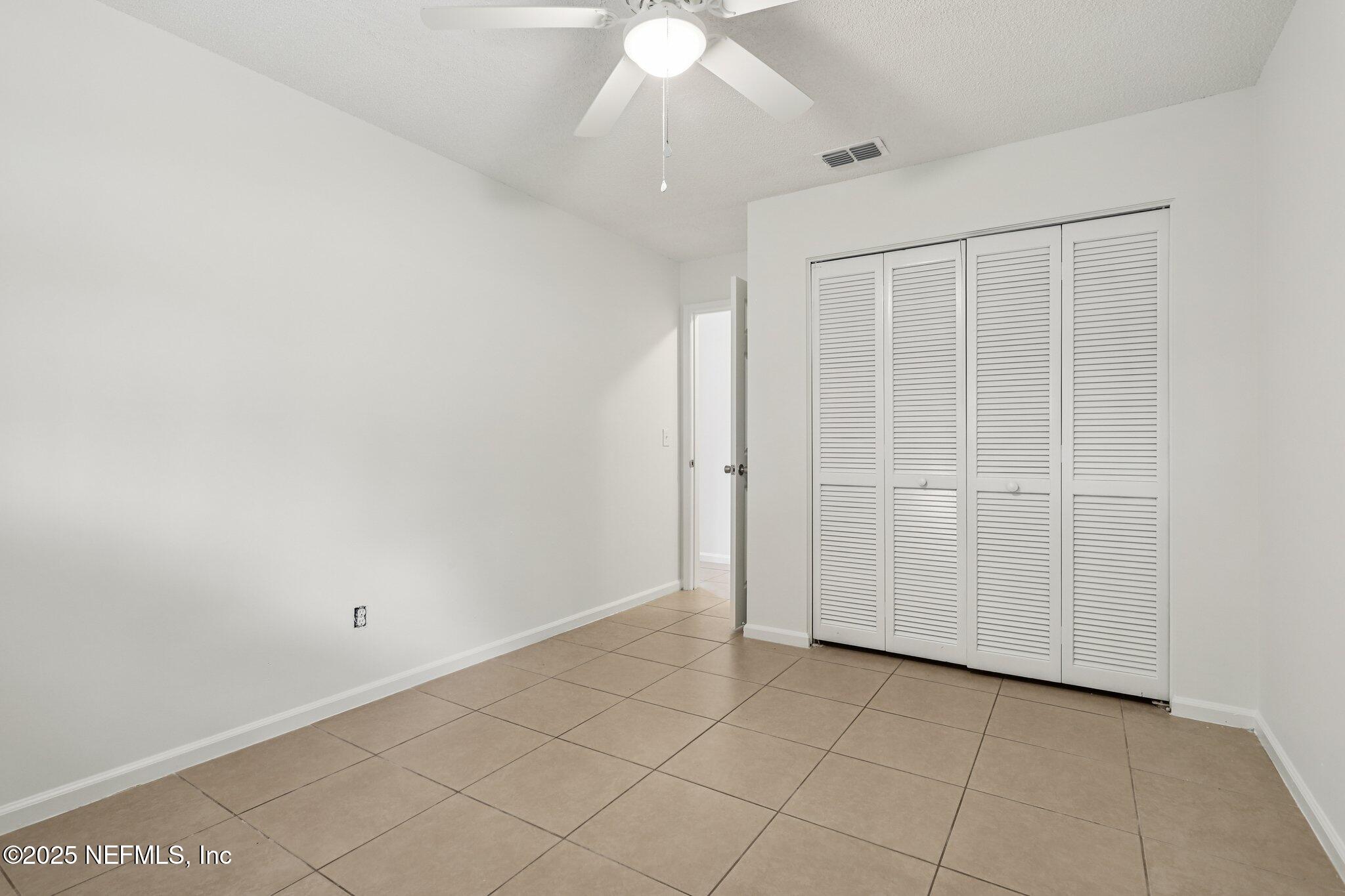 3801 Crown Point Road, Unit 2024 Jacksonville, FL 32257 - Photo 15 of 36 an empty room with a ceiling fan and carpet