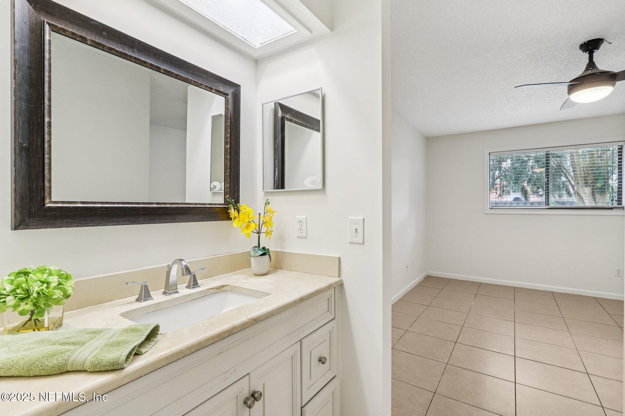 3801 Crown Point Road, Unit 2024 Jacksonville, FL 32257 - Photo 19 of 36 a bathroom with a granite countertop sink and a mirror