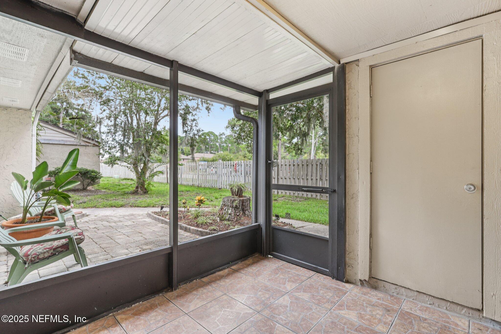 3801 Crown Point Road, Unit 2024 Jacksonville, FL 32257 - Photo 23 of 36 a view of a porch with furniture and garden