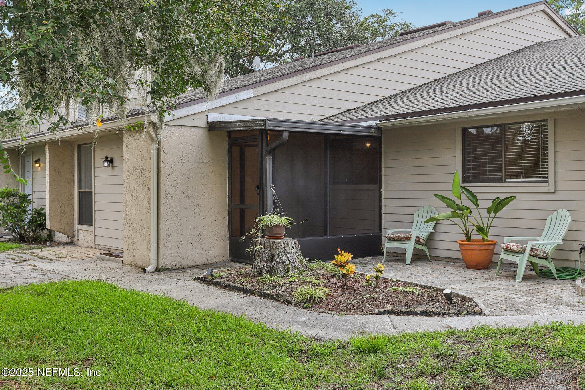 3801 Crown Point Road, Unit 2024 Jacksonville, FL 32257 - Photo 25 of 36 a backyard of house with potted plants and a bench