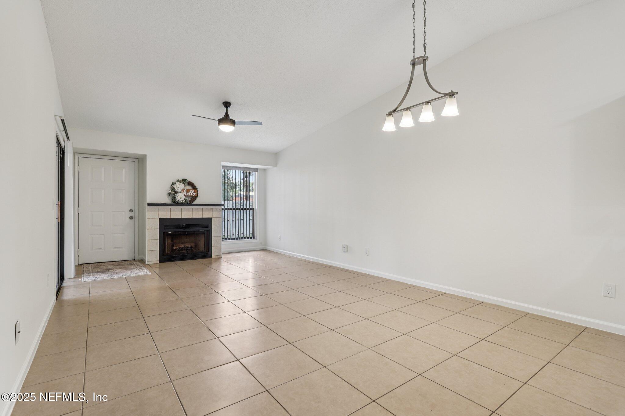 3801 Crown Point Road, Unit 2024 Jacksonville, FL 32257 - Photo 4 of 36 a view of a livingroom with a fireplace and a chandelier fan