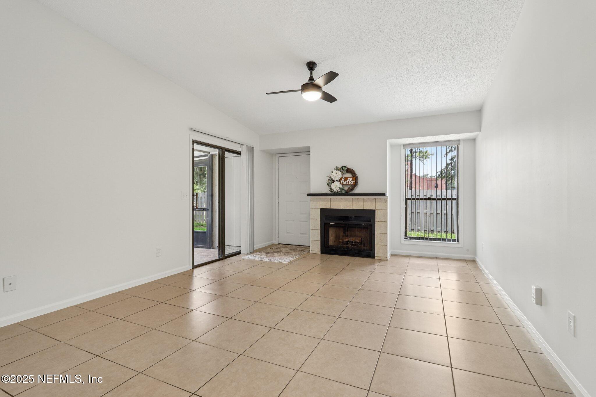3801 Crown Point Road, Unit 2024 Jacksonville, FL 32257 - Photo 6 of 36 a view of an empty room with a fireplace and a window