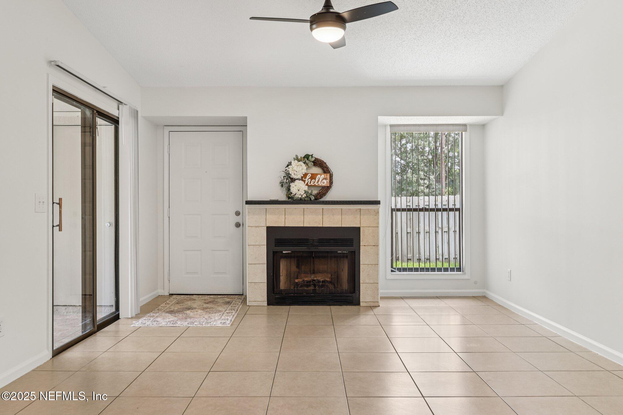 3801 Crown Point Road, Unit 2024 Jacksonville, FL 32257 - Photo 7 of 36 a living room with furniture and a fireplace