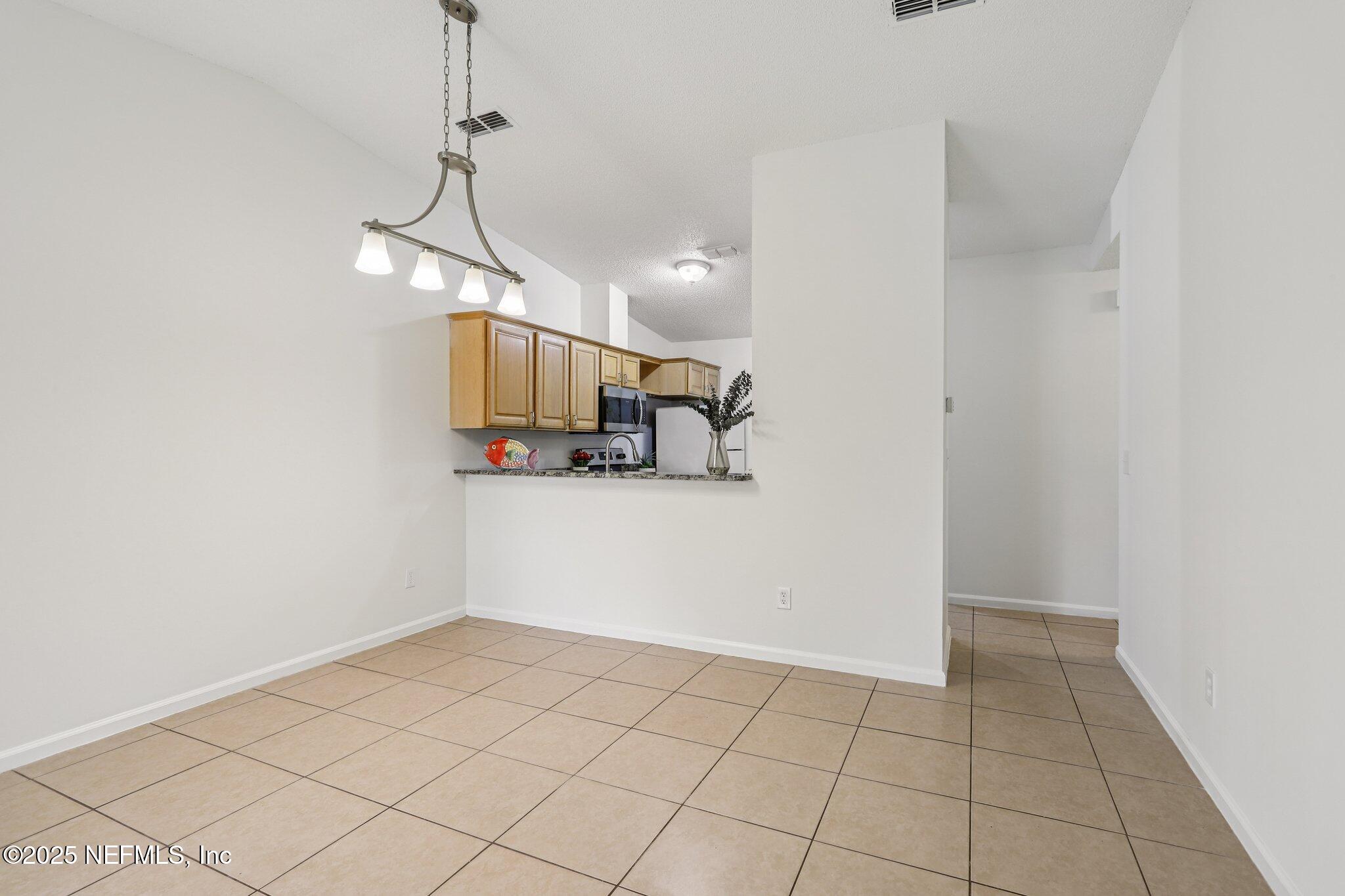 3801 Crown Point Road, Unit 2024 Jacksonville, FL 32257 - Photo 8 of 36 a view of a kitchen with a dishwasher and a microwave
