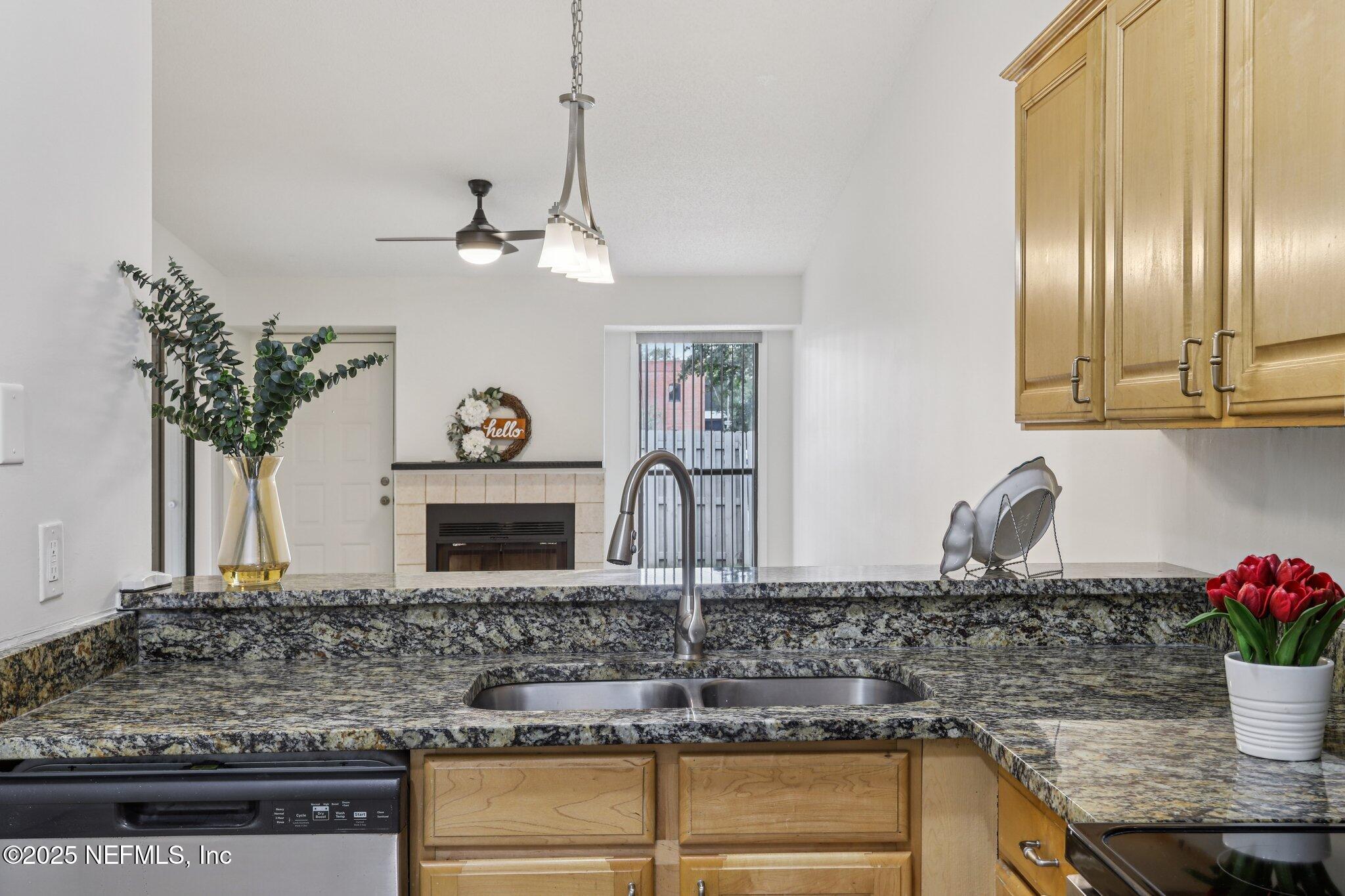 3801 Crown Point Road, Unit 2024 Jacksonville, FL 32257 - Photo 10 of 36 a kitchen with stainless steel appliances granite countertop a sink a stove and cabinets