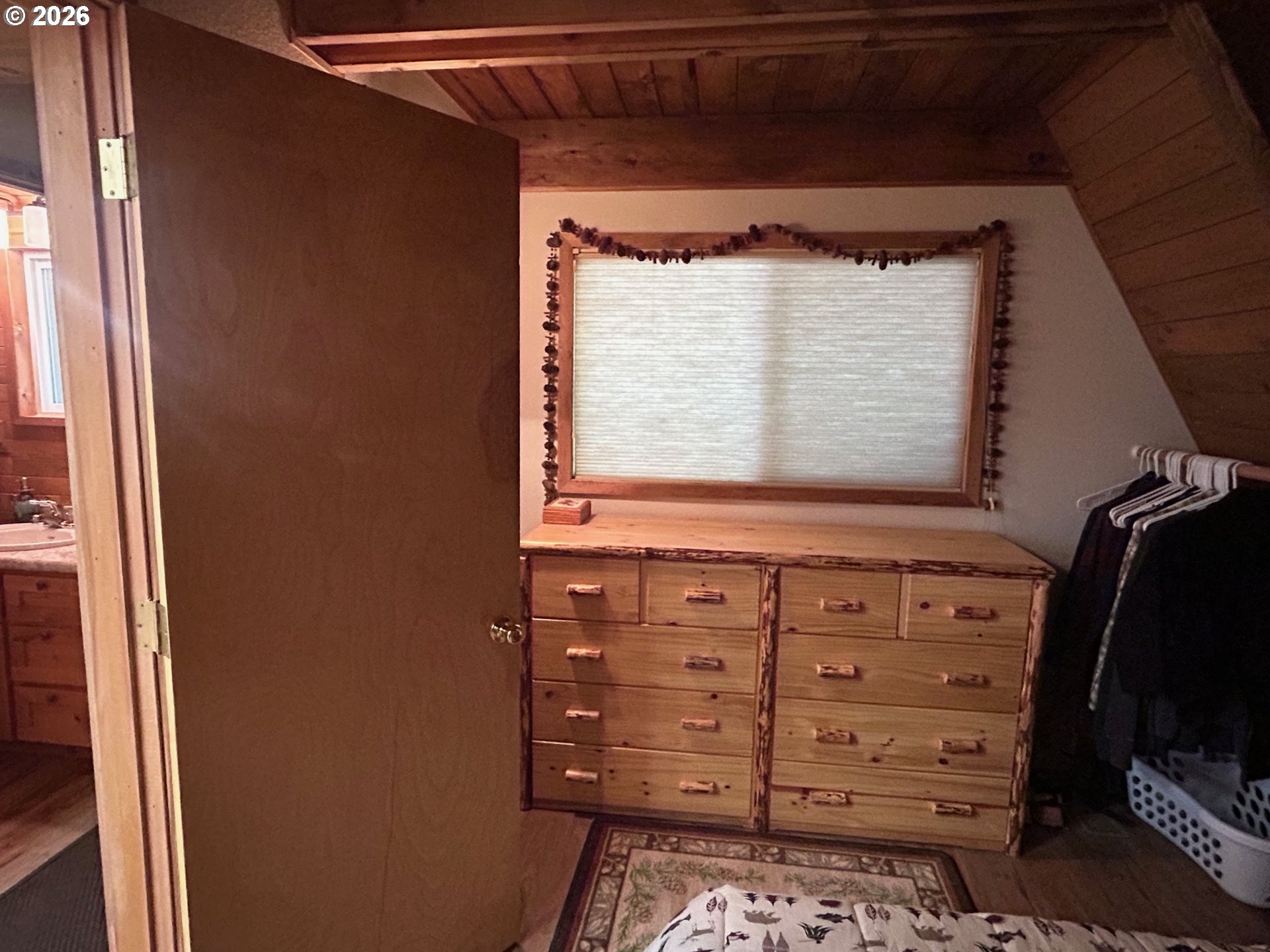 77120 Spout Springs Road Weston, OR 97886 - Photo 21 of 37 a view of a dresser with window and cabinet