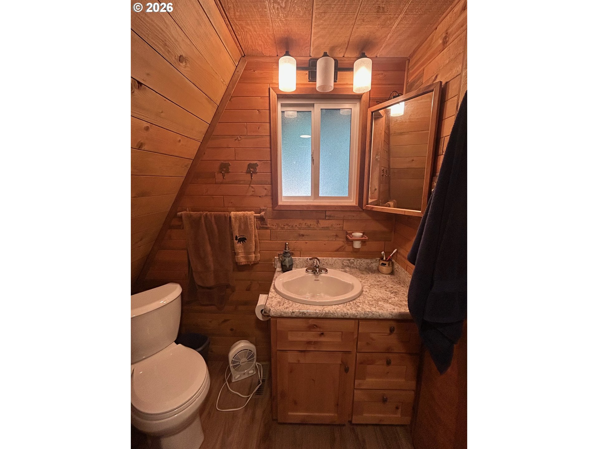 77120 Spout Springs Road Weston, OR 97886 - Photo 22 of 37 a bathroom with a toilet sink and mirror