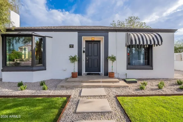 a front view of a house with garden
