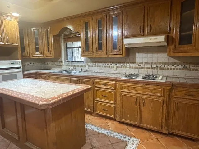 a kitchen with stainless steel appliances granite countertop a sink and cabinets