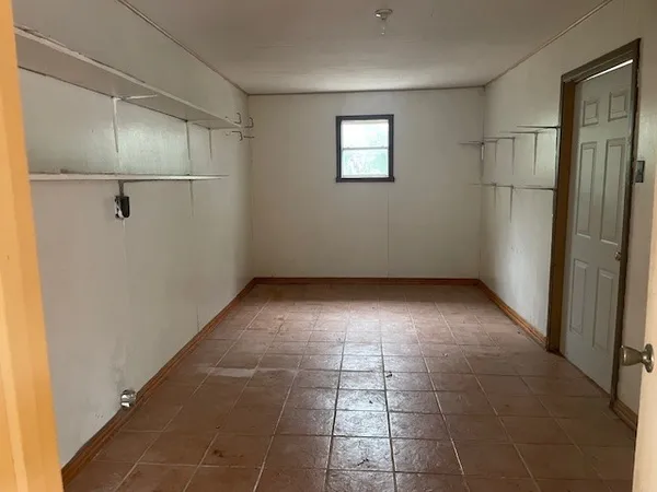 a view of an empty room with a window