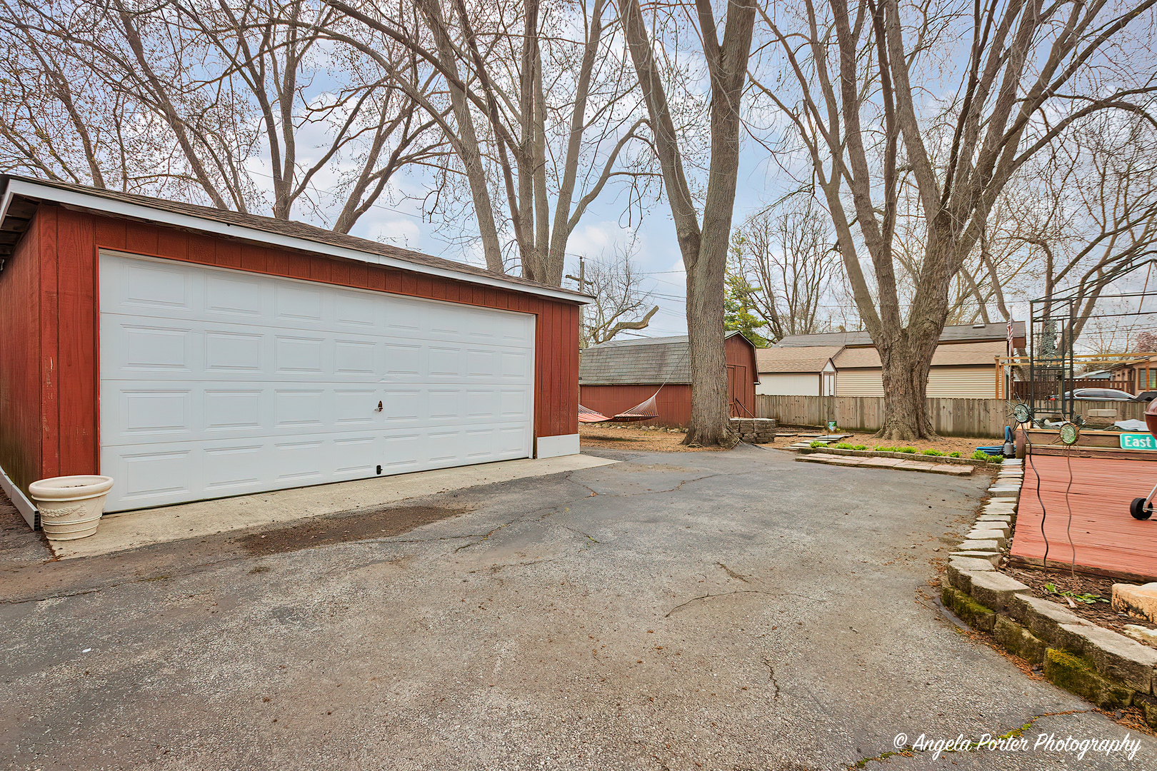 390 Willow Road Wauconda, IL 60084 - Photo 2 of 26 a backyard of a house with garage and trees