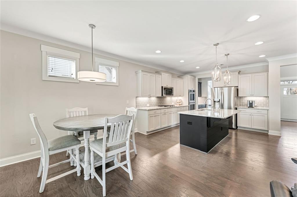920 Traditions Way Jefferson, GA 30549 - Photo 12 of 40 a kitchen with kitchen island a white cabinets and wooden floor