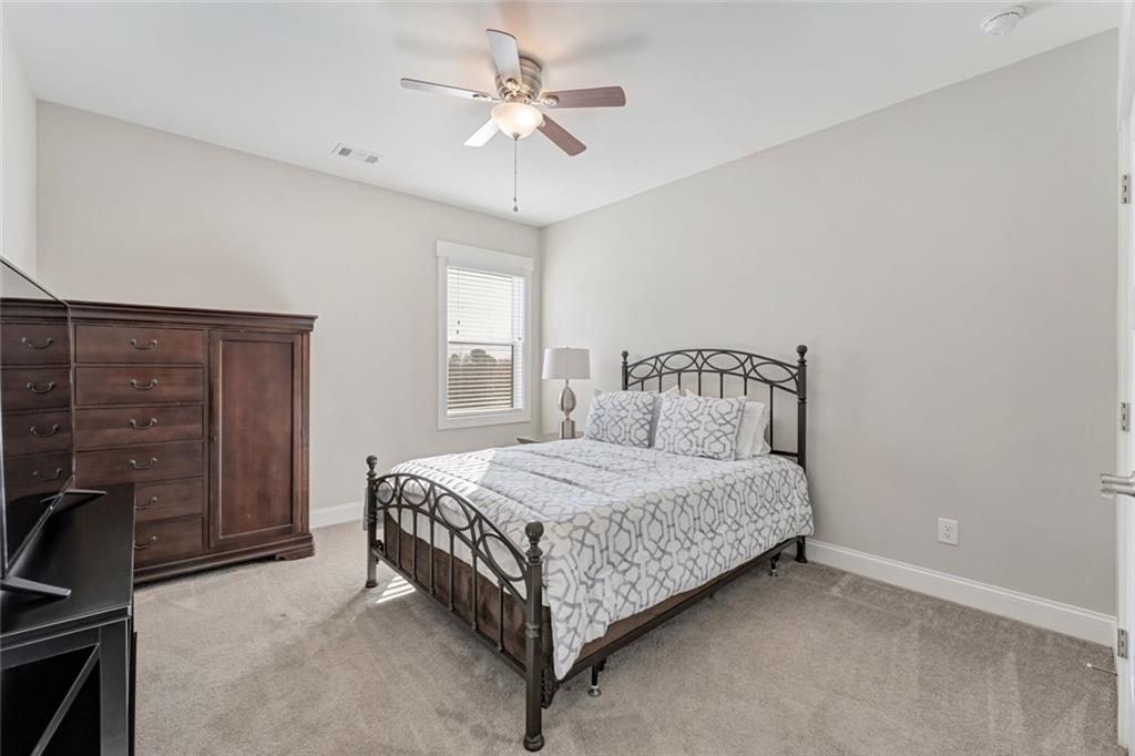 920 Traditions Way Jefferson, GA 30549 - Photo 27 of 40 a bedroom with a bed and a refrigerator