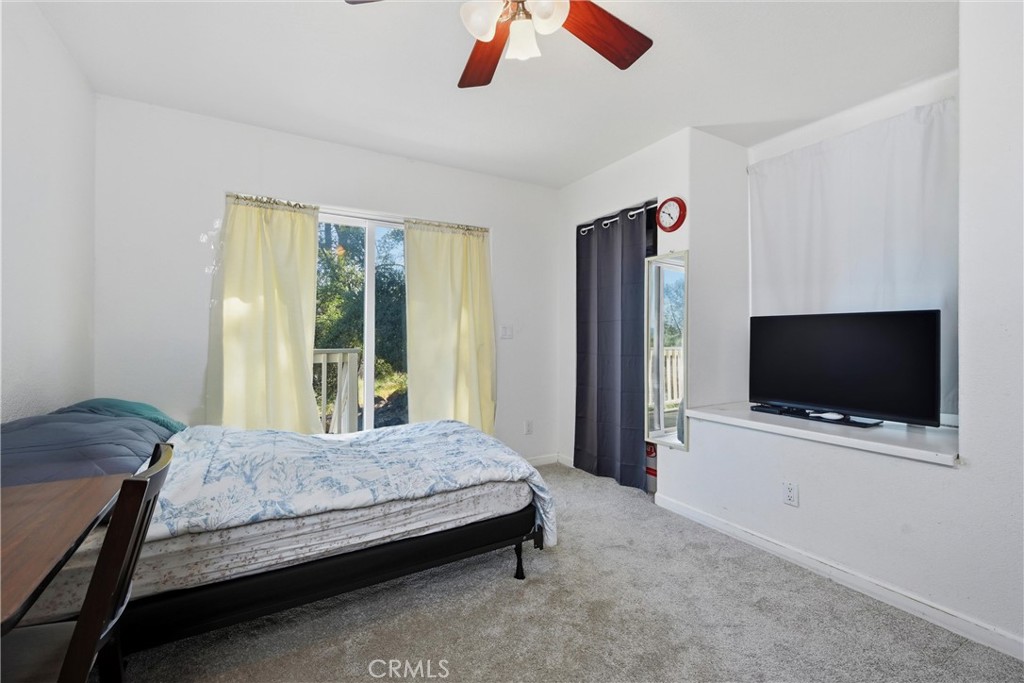 18685 Oak Grove Road Hidden Valley Lake, CA 95467 - Photo 15 of 52 a bedroom with a bed and a flat screen tv