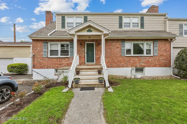 a front view of a house with a yard