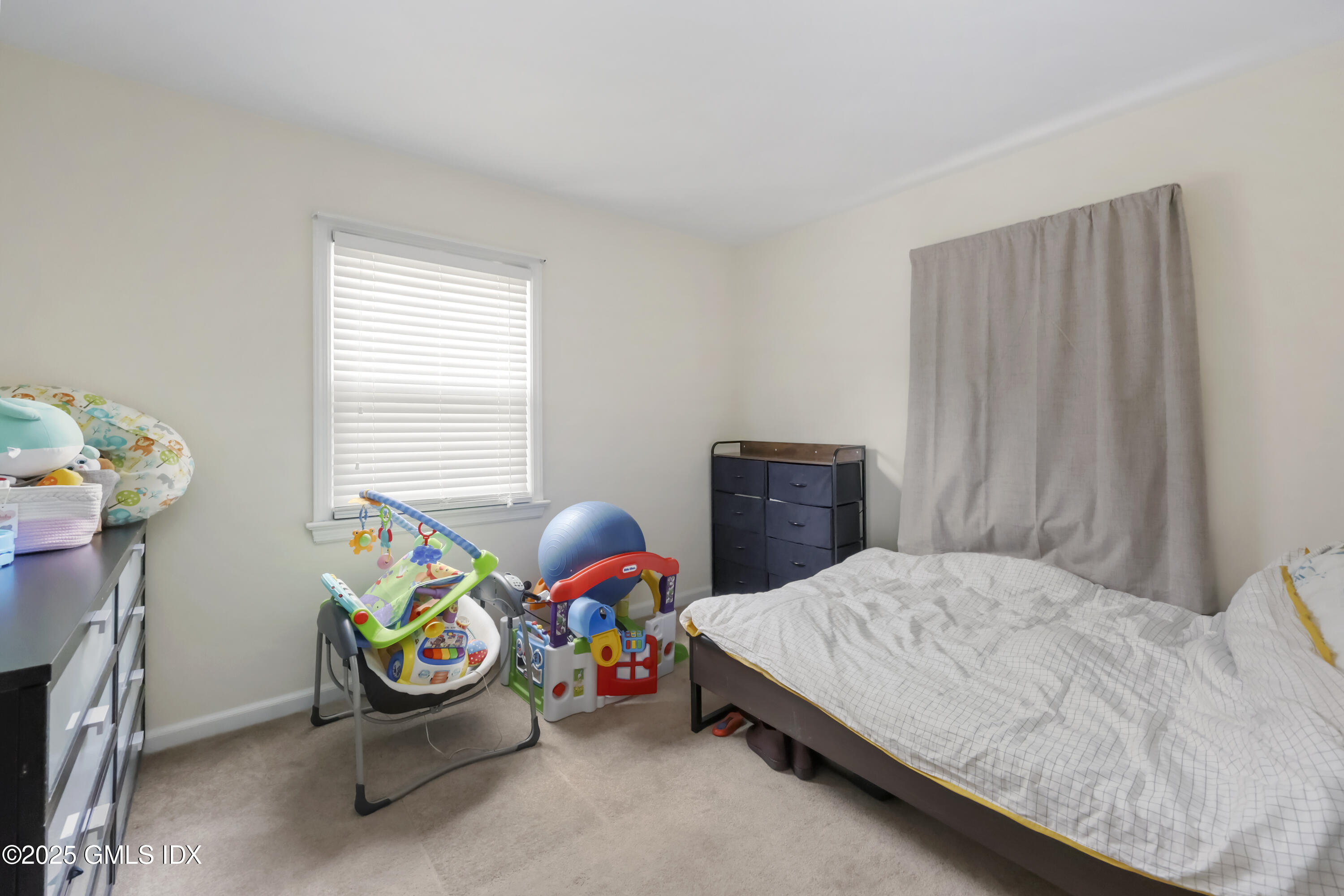 54 Rodwell Avenue, Unit 1 Greenwich, CT 06830 - Photo 11 of 14 a bedroom with a bed and a window