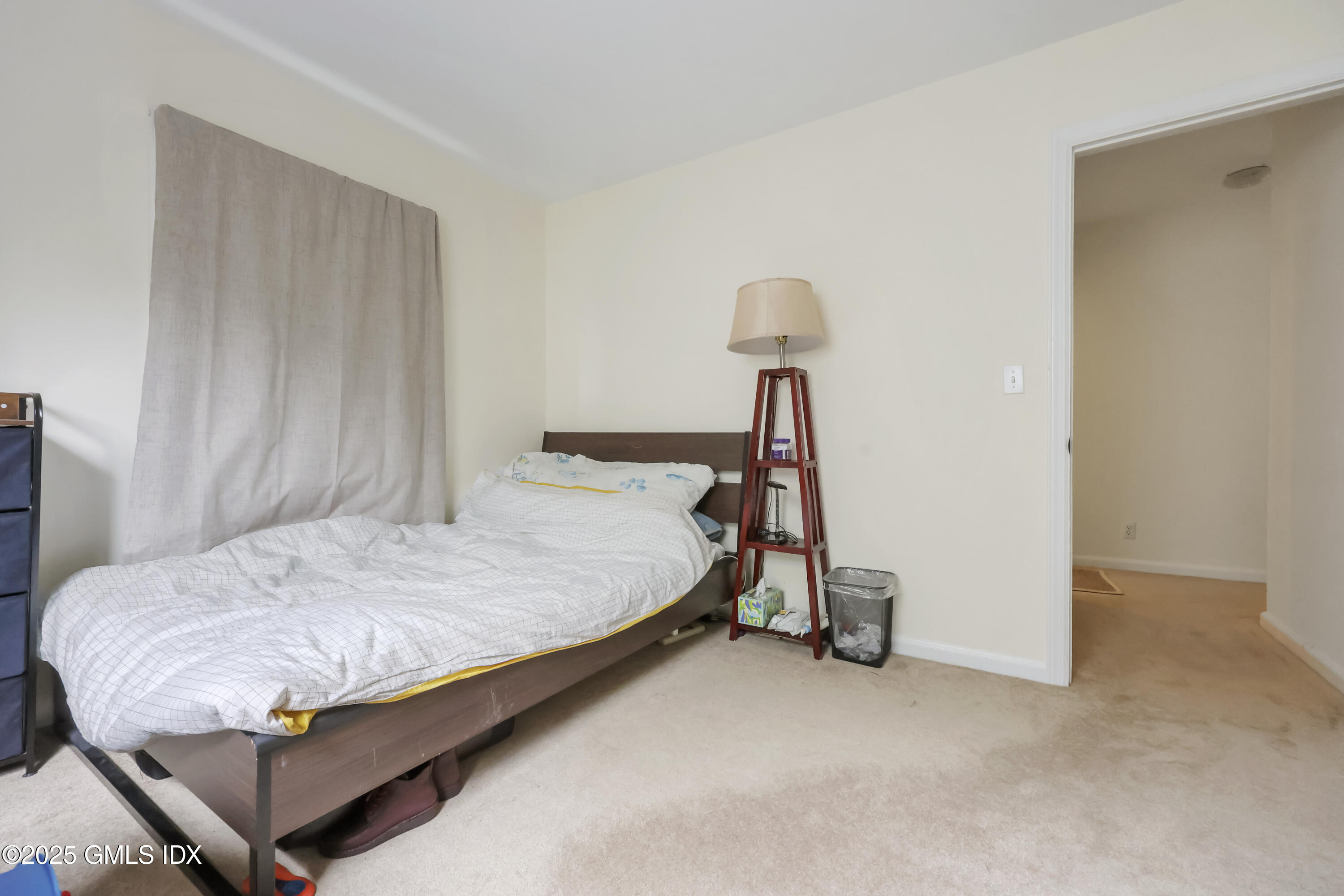 54 Rodwell Avenue, Unit 1 Greenwich, CT 06830 - Photo 12 of 14 a bed sitting in a bedroom next to a window and a lamp