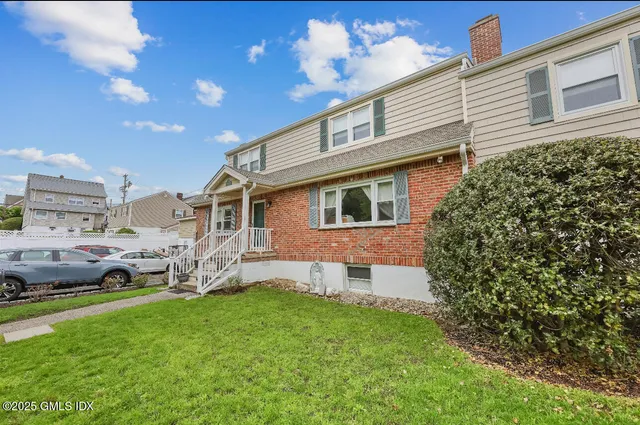 a front view of a house with a garden