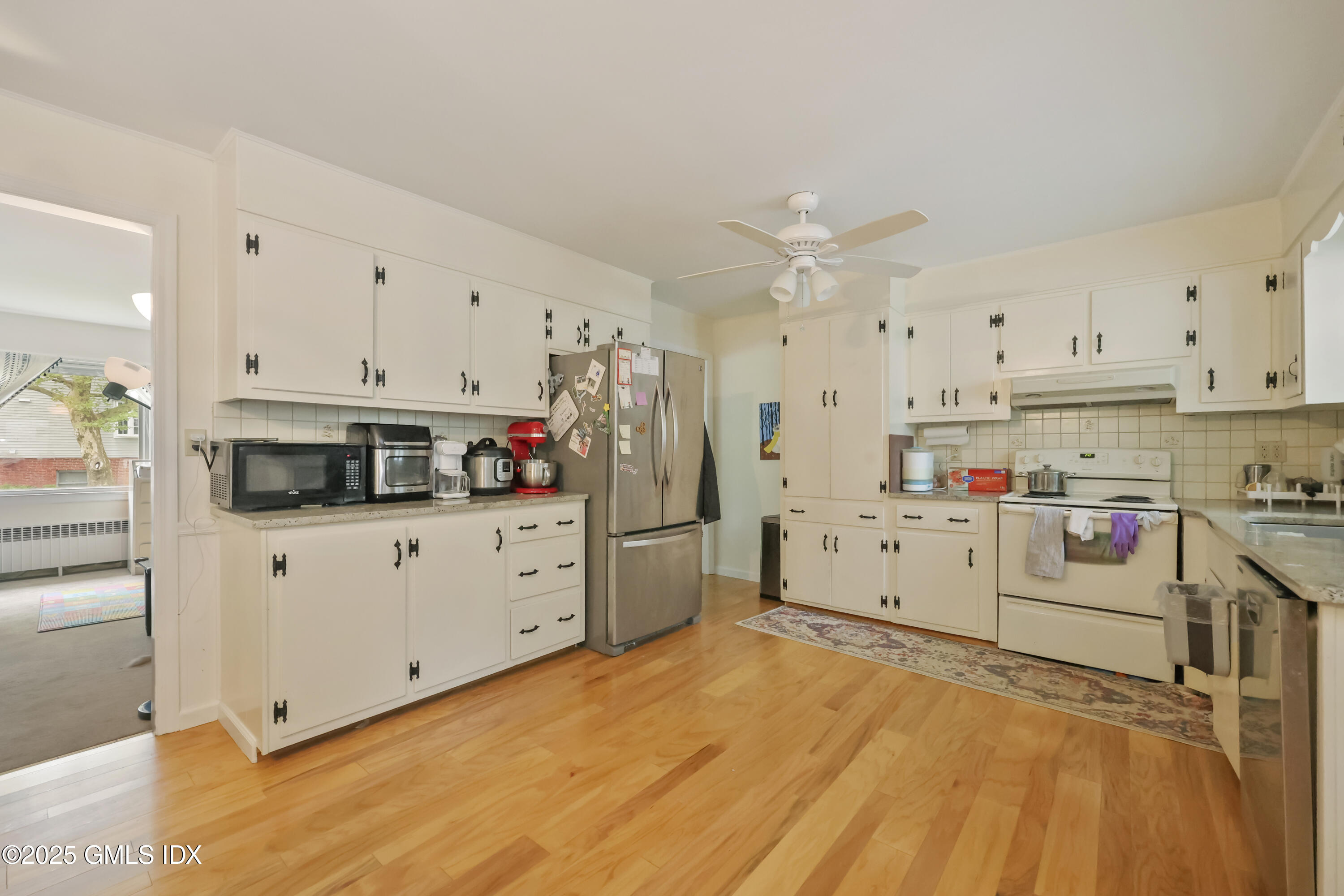 54 Rodwell Avenue, Unit 1 Greenwich, CT 06830 - Photo 3 of 14 a kitchen with white cabinets and white appliances