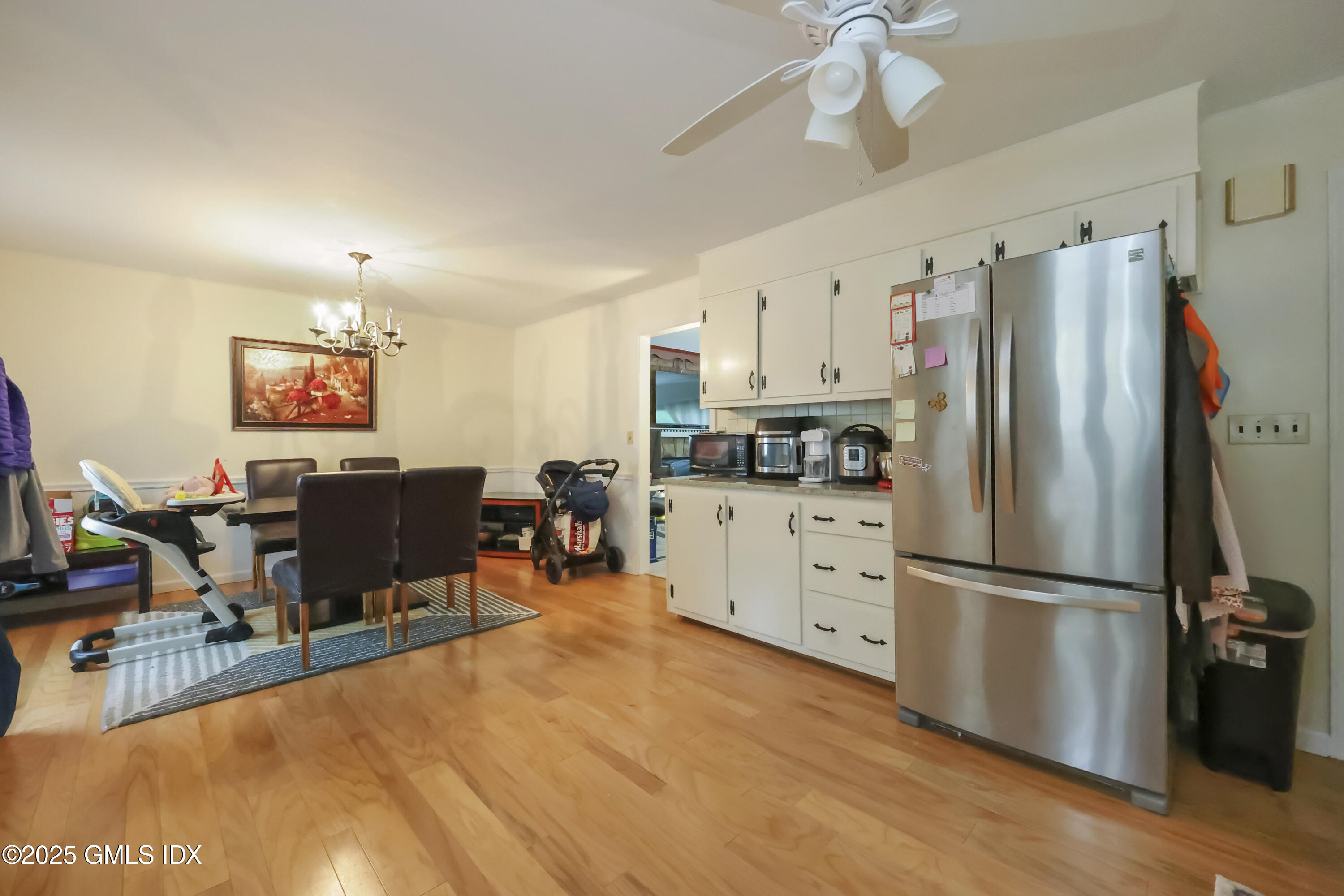 54 Rodwell Avenue, Unit 1 Greenwich, CT 06830 - Photo 4 of 14 a kitchen with stainless steel appliances a refrigerator sink cabinets and wooden floor