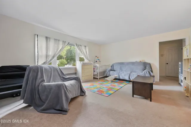 a bedroom with a bed and a large window