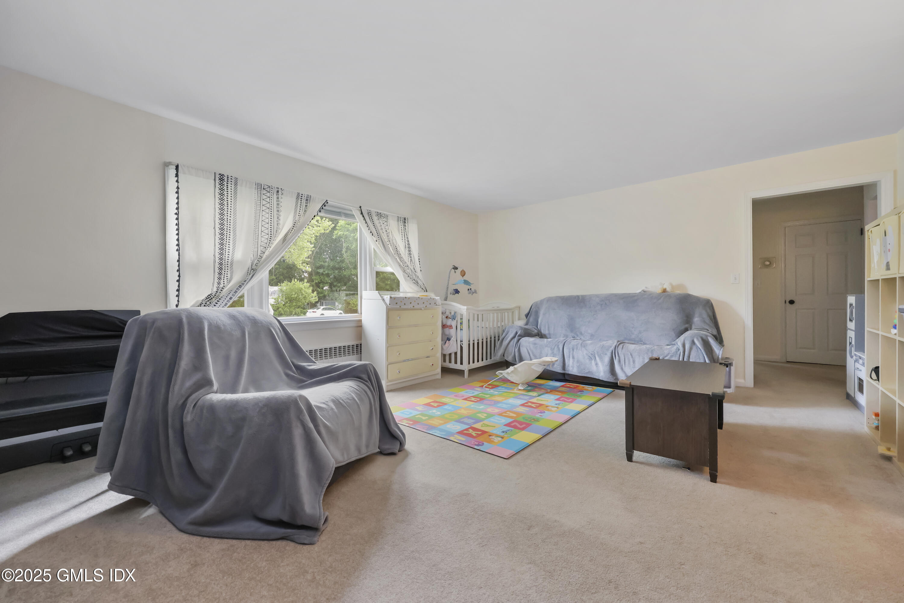 54 Rodwell Avenue, Unit 1 Greenwich, CT 06830 - Photo 6 of 14 a bedroom with a bed and a large window