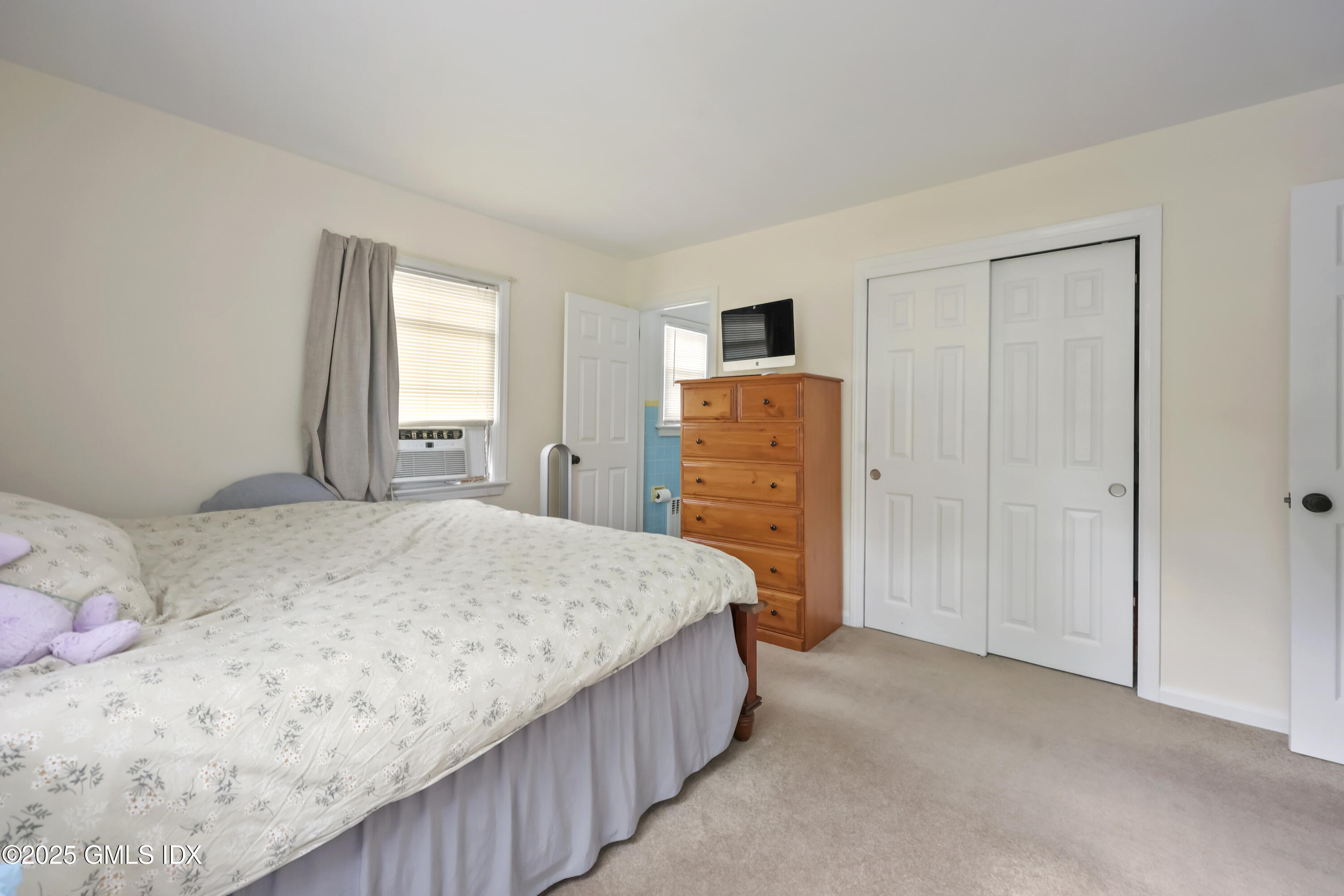 54 Rodwell Avenue, Unit 1 Greenwich, CT 06830 - Photo 9 of 14 a bedroom with a bed and a window