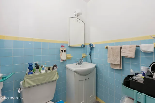 a bathroom with a sink toilet and a mirror