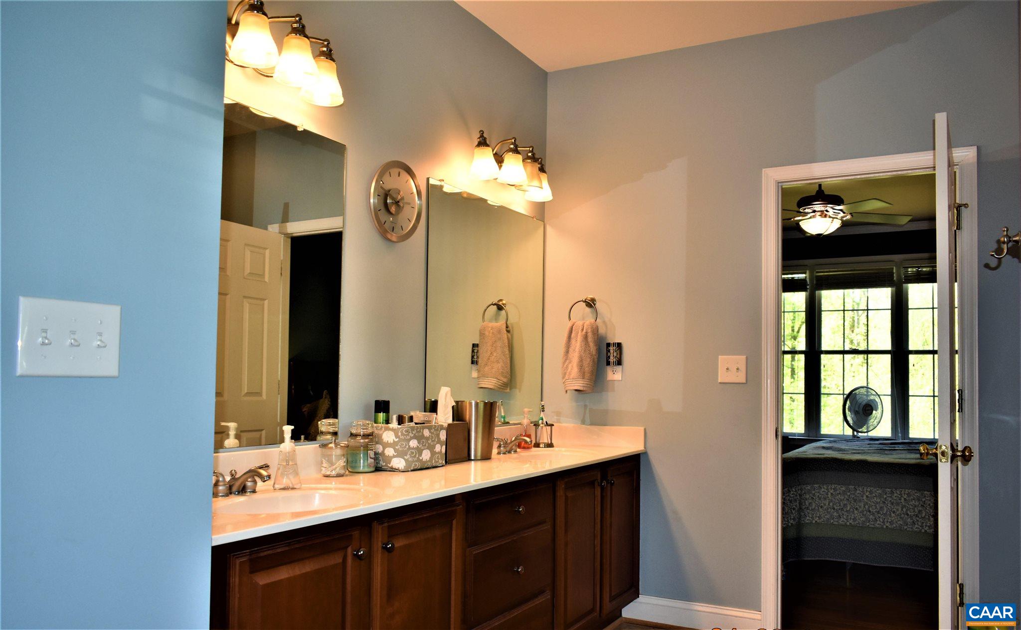 1333 Middle River Road Stanardsville, VA 22973 - Photo 20 of 31 a bathroom with a double vanity sink and a mirror