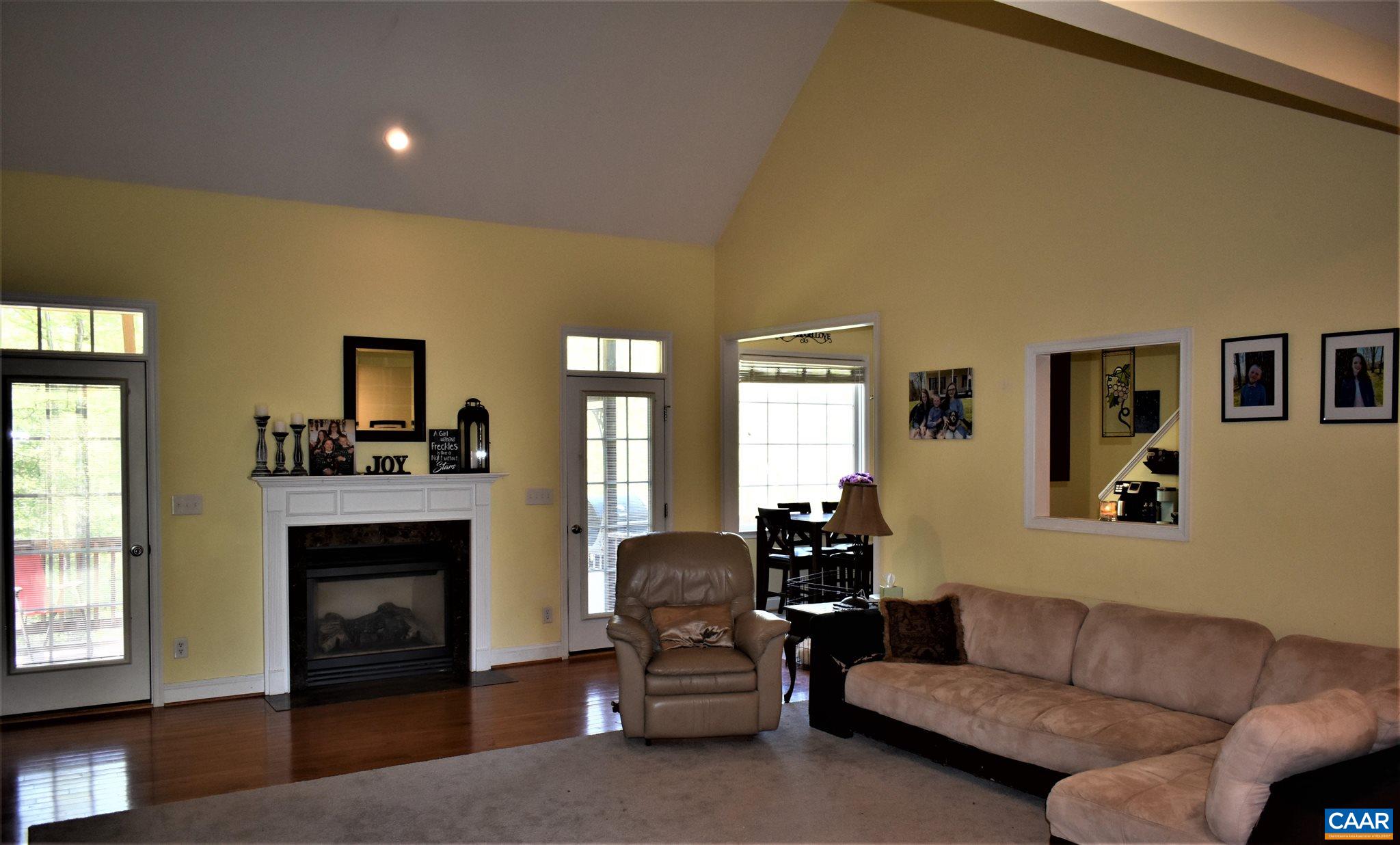 1333 Middle River Road Stanardsville, VA 22973 - Photo 7 of 31 a living room with furniture a fireplace and a flat screen tv