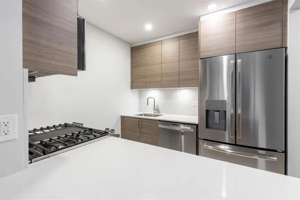 a kitchen with stainless steel appliances a refrigerator and a sink