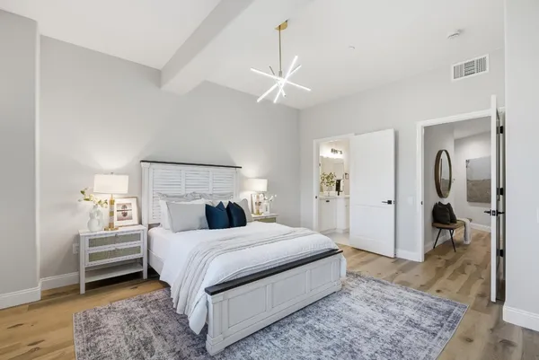 a bedroom with a bed and a view of en suite bathroom