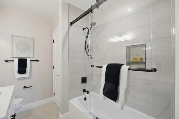 a bathroom with a toilet and a shower