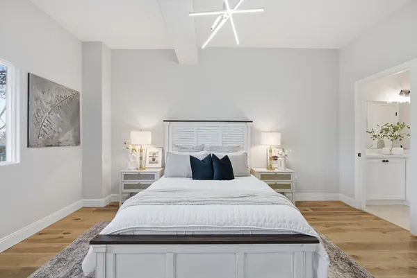 a bedroom with a bed and wooden floor