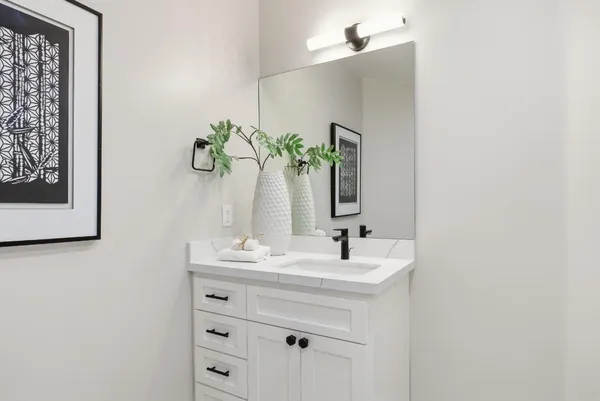 a bathroom with a sink a vanity and a mirror