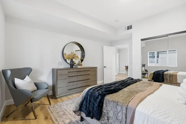 a bedroom with a bed and chair