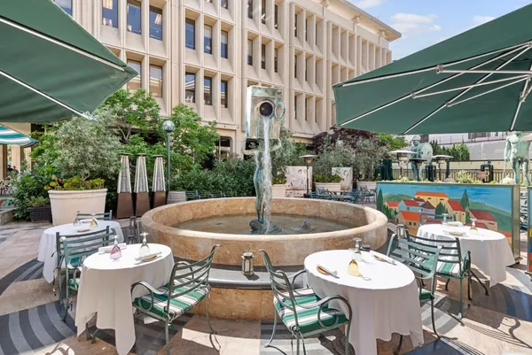 a view of a patio with table and chairs potted plants