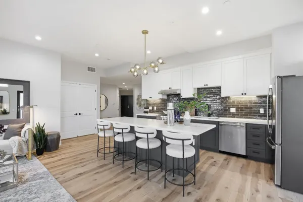 a large kitchen with a table and chairs