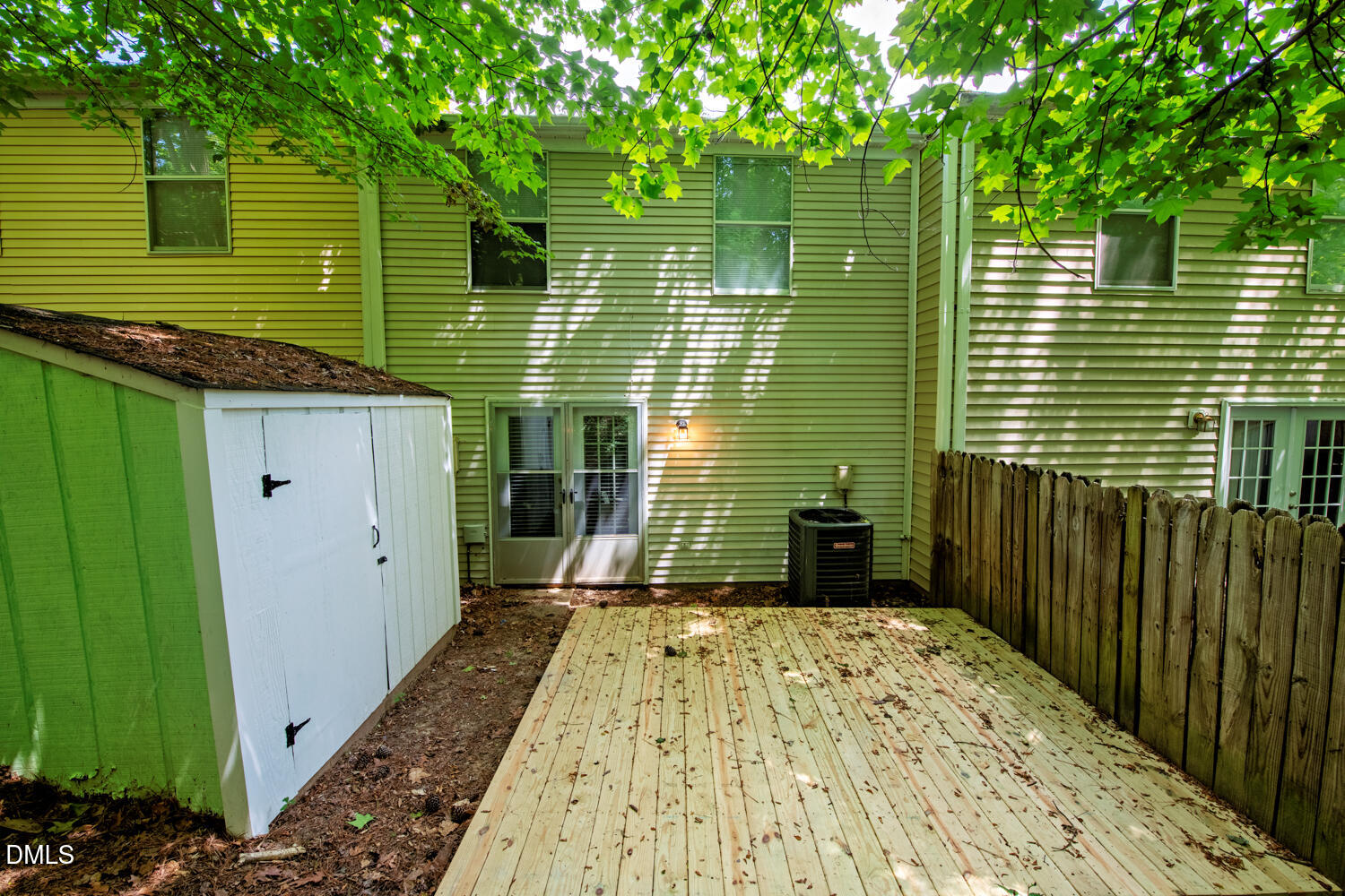 1135 Villa Green Court Raleigh, NC 27612 - Photo 16 of 17 a view of a backyard with a large tree