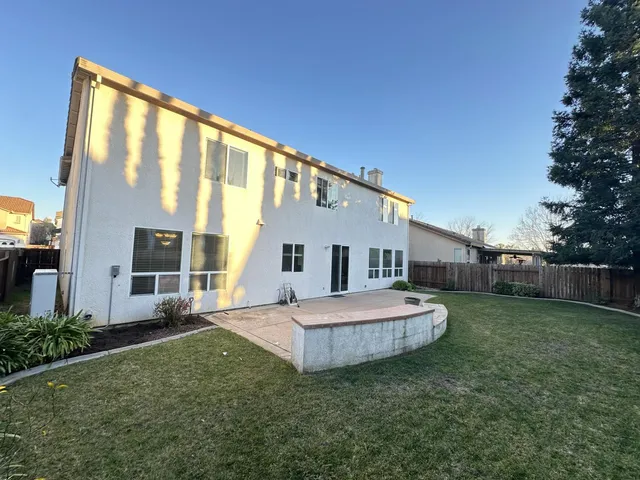 a big house with a big yard and more large trees