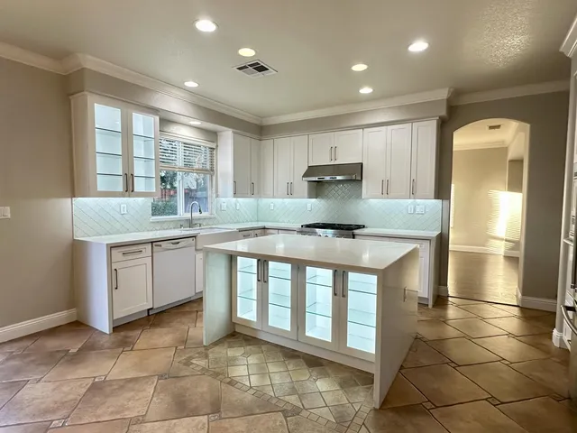 a kitchen with a sink appliances and cabinets